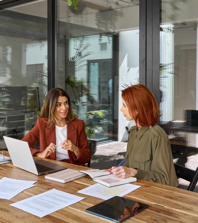 two woman sitting in a conference room two woman sitting in a conference room