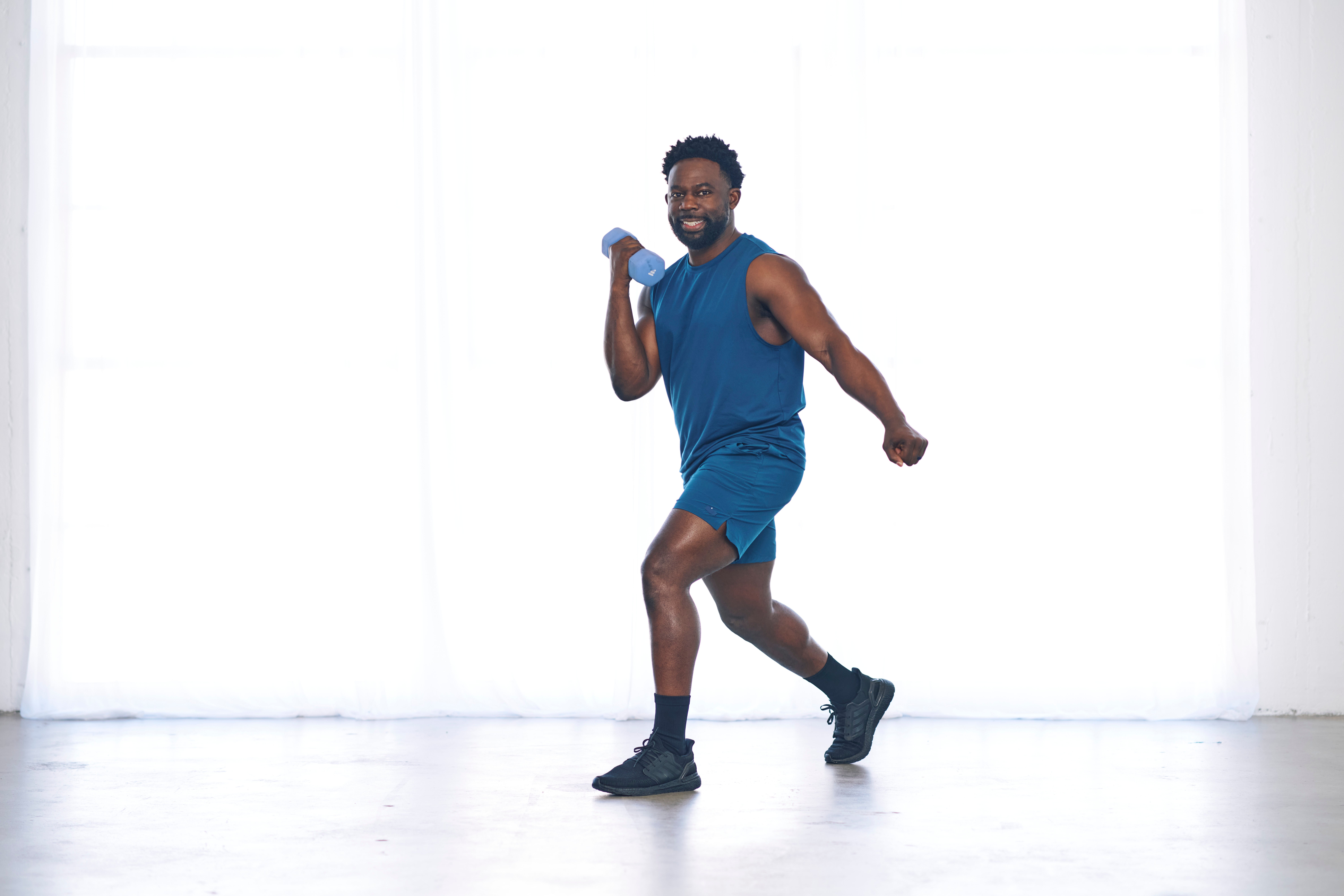 FitOn Health instructor holding a dumbbell