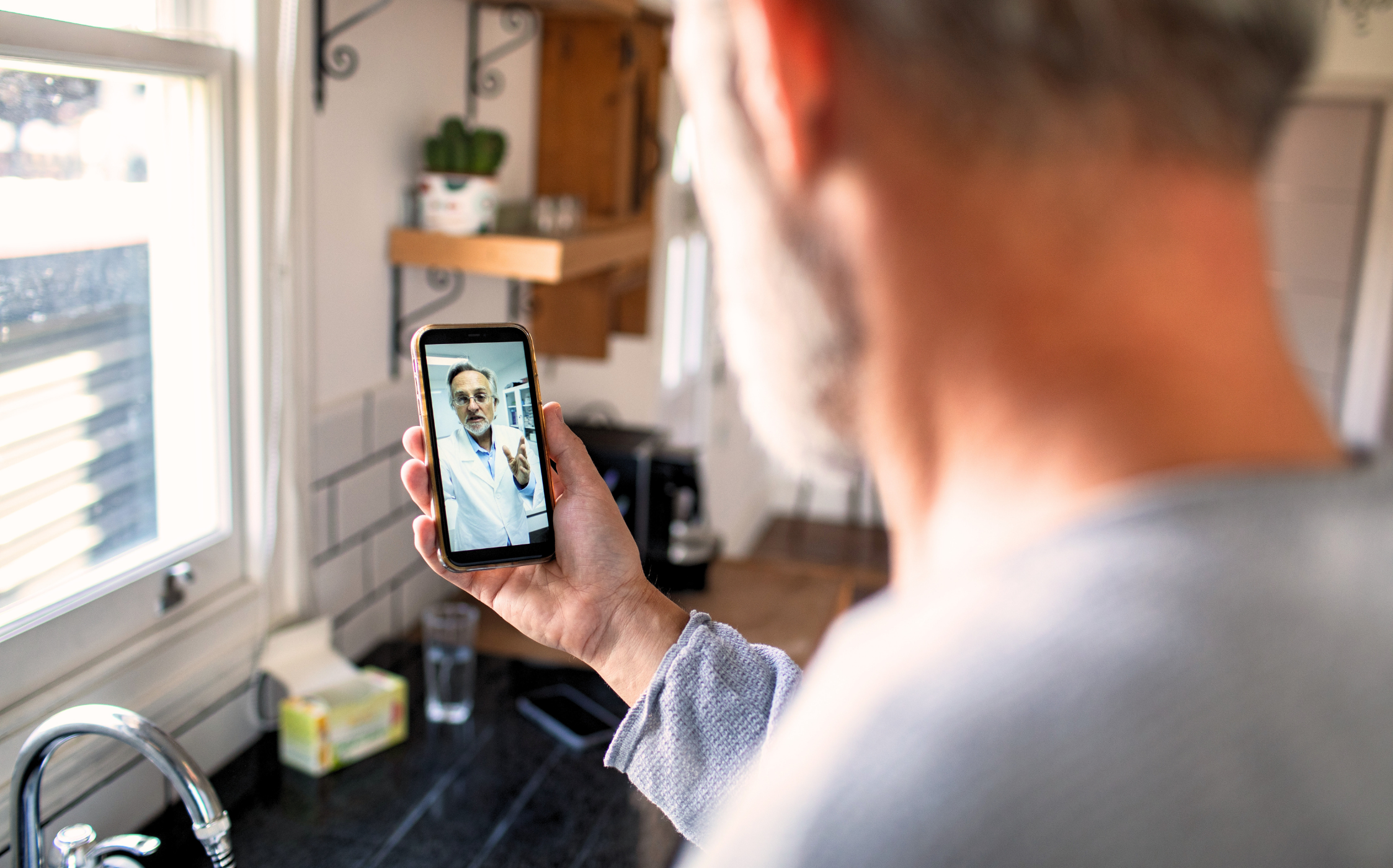 man speaking with a virtual care physician via mobile