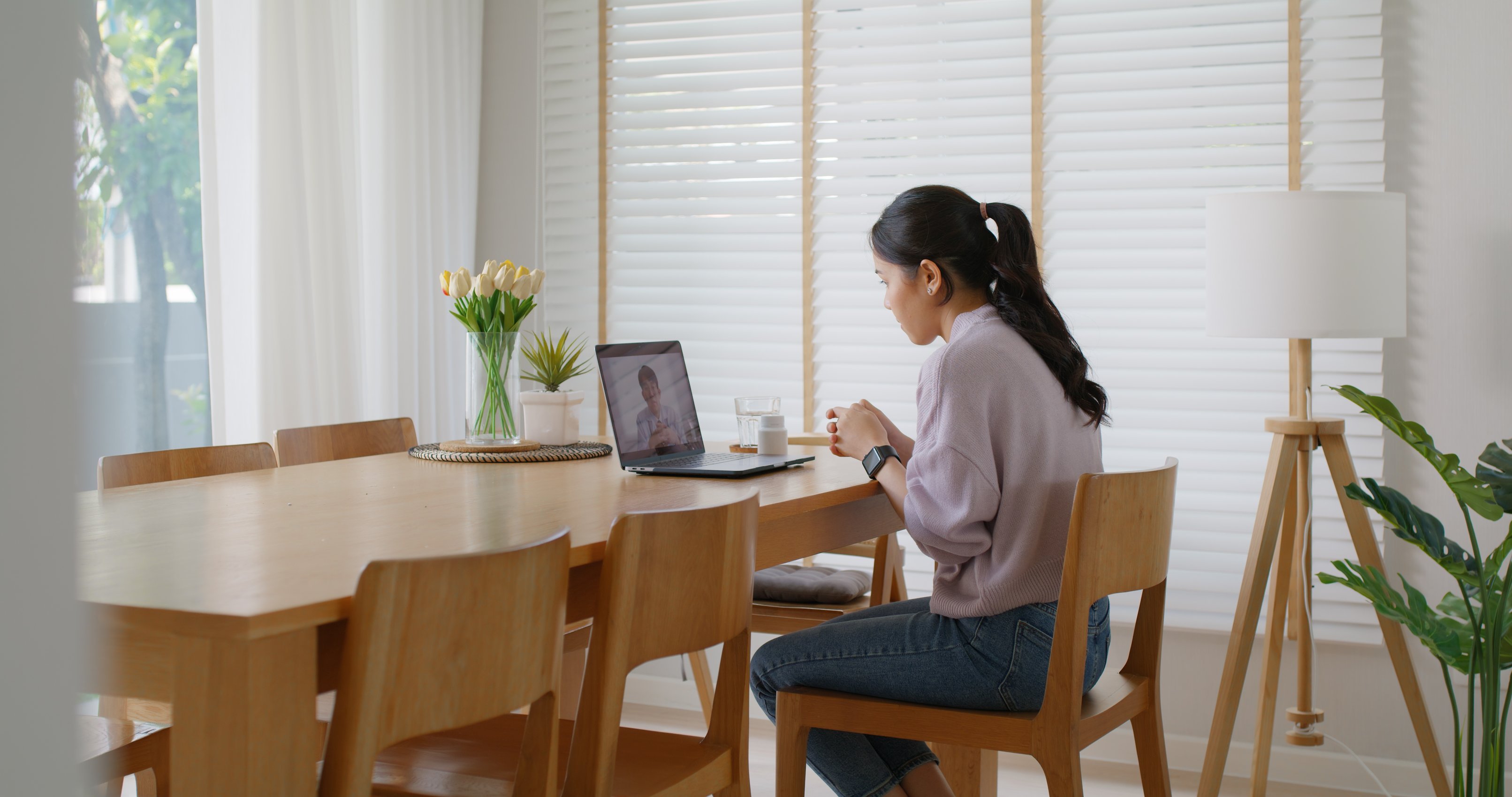 Woman speaking with a Revive Health physician from her laptop