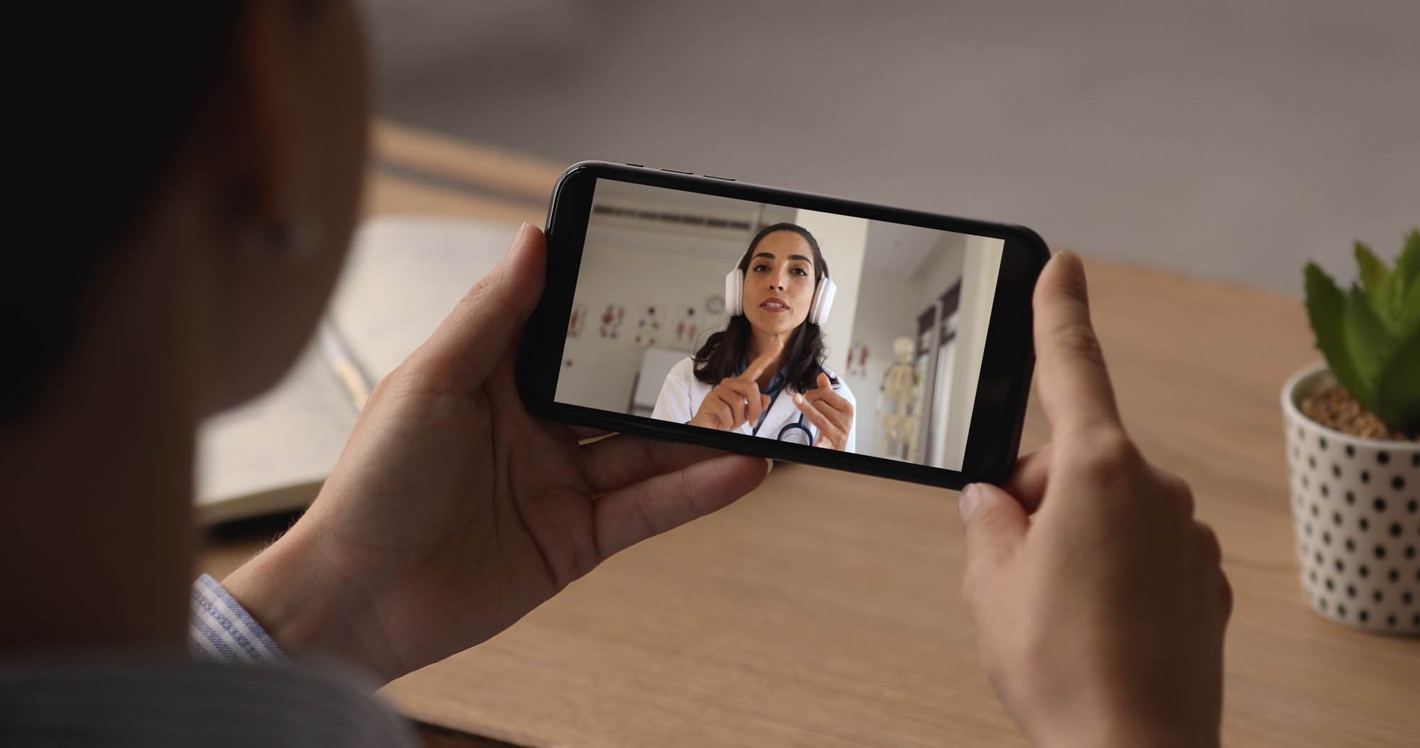 Woman taking telehealth call for primary care. Woman taking telehealth call for primary care.
